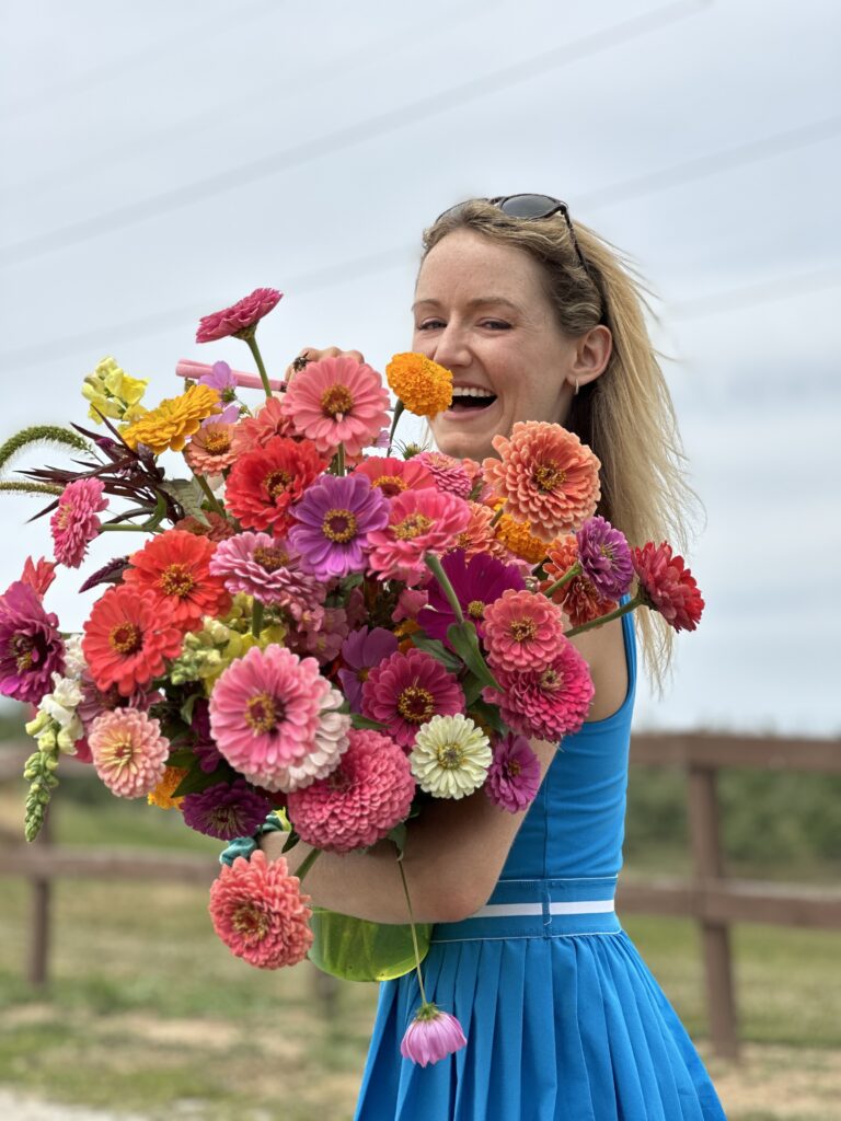 emily meyers holding zinnia flowers