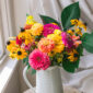 white vase with pink and yellow flowers