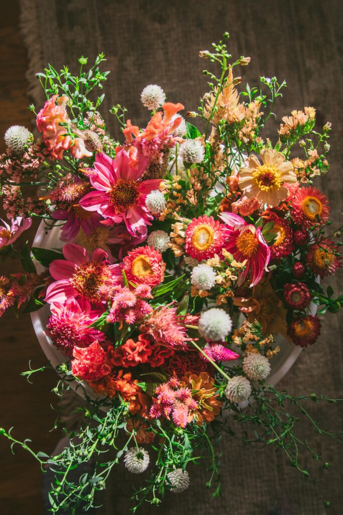 bucket of fresh flowers including dahlias and zinnias